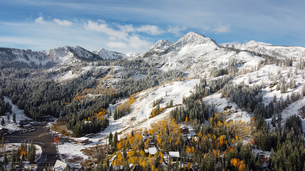 Snowy mountain landscape in the morning with yellow fall aspen trees.